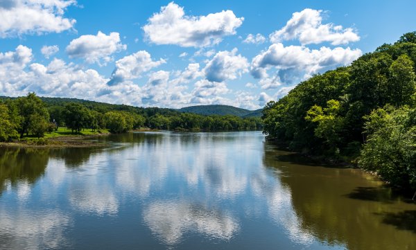 Clouds reflecting up on the Allegheny river in Tidioute, Pennsylvania, USA on a sunny summer day