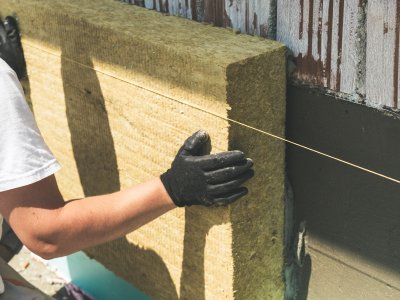 Worker installing insulation on a passive house facade